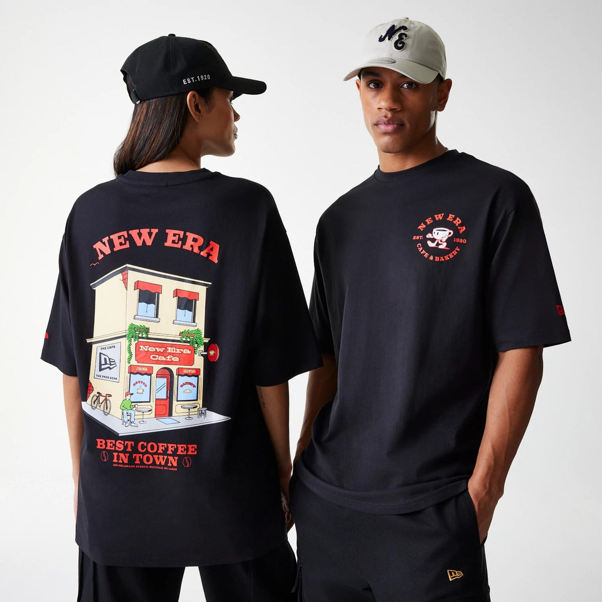 The Male model is wearing New Era Cafe Graphic Black Oversized T-Shirt 1