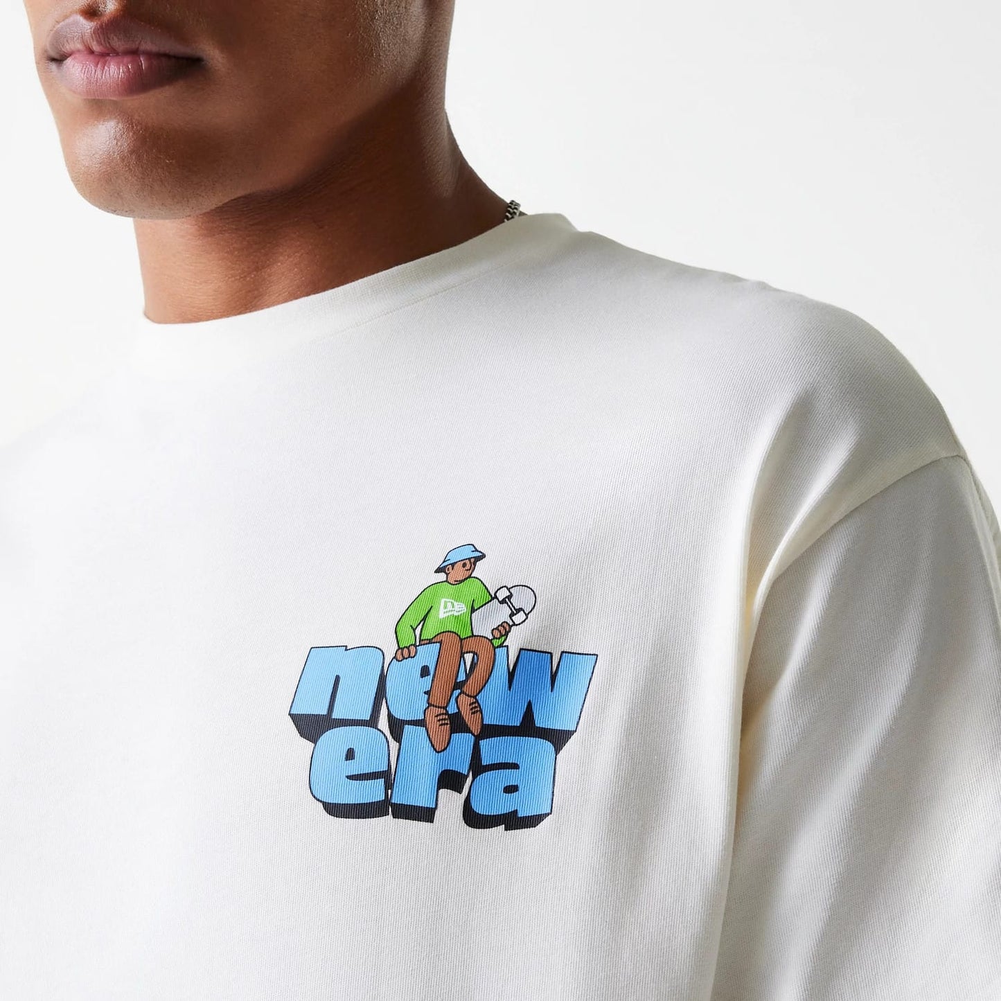 The Male model is wearing New Era Skate Graphic Open White Oversized T-Shirt 8