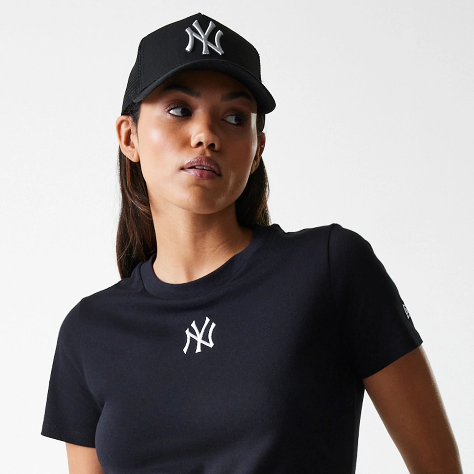 The Female model is wearing New York Yankees Womens MLB Midi League Essential Black T-Shirt 6