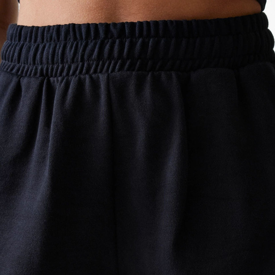 The Female model is wearing New York Yankees Womens MLB Midi League Essential Black Shorts 5