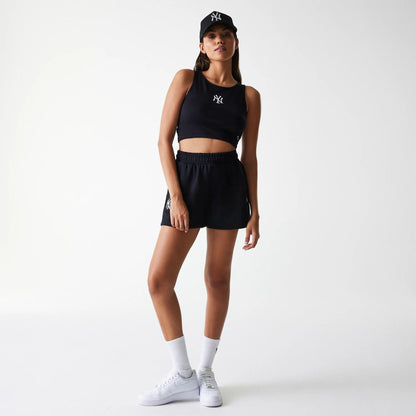 The Female model is wearing New York Yankees Womens MLB Midi League Essential Black Shorts 7