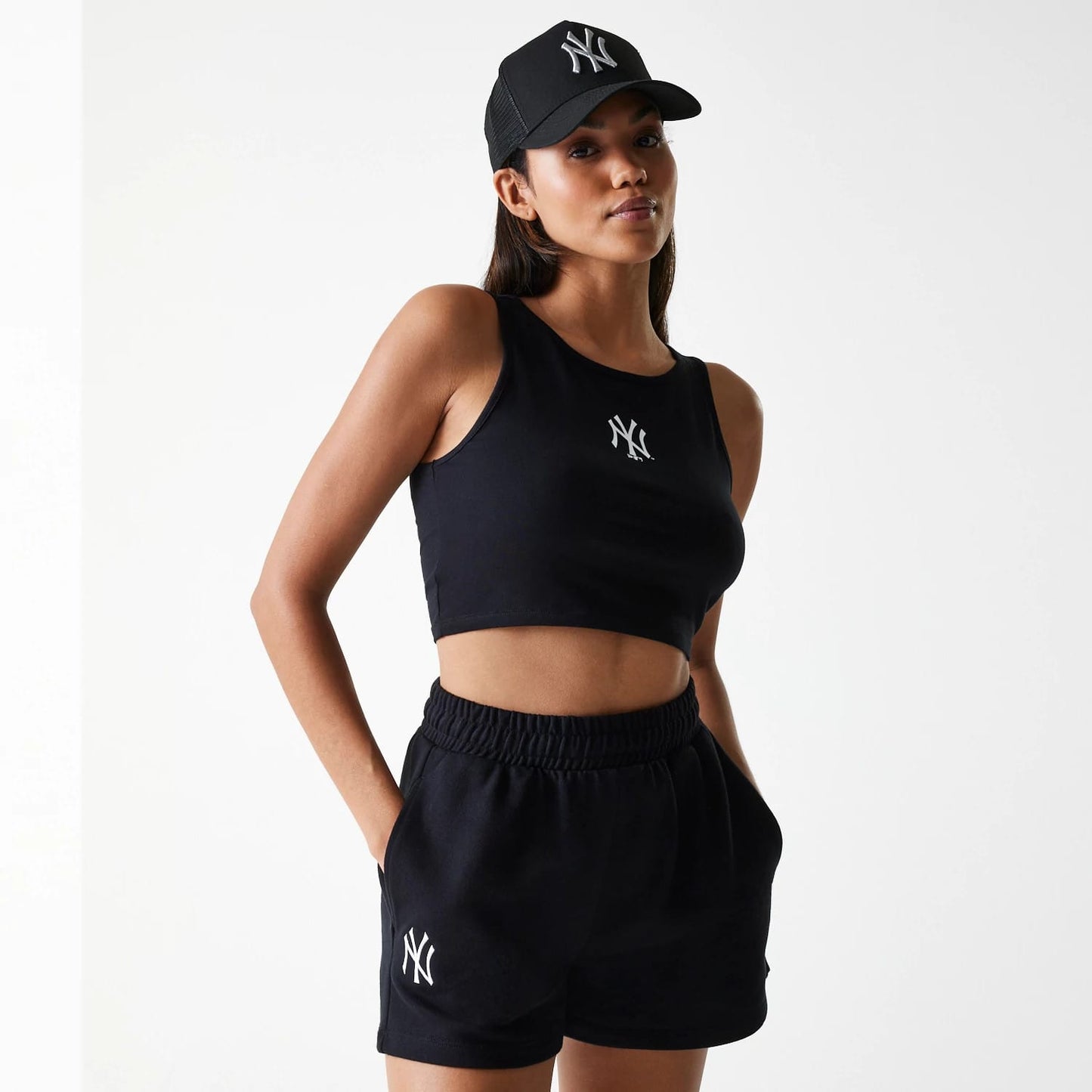 The Female model is wearing New York Yankees Womens MLB Midi League Essential Black Shorts 1