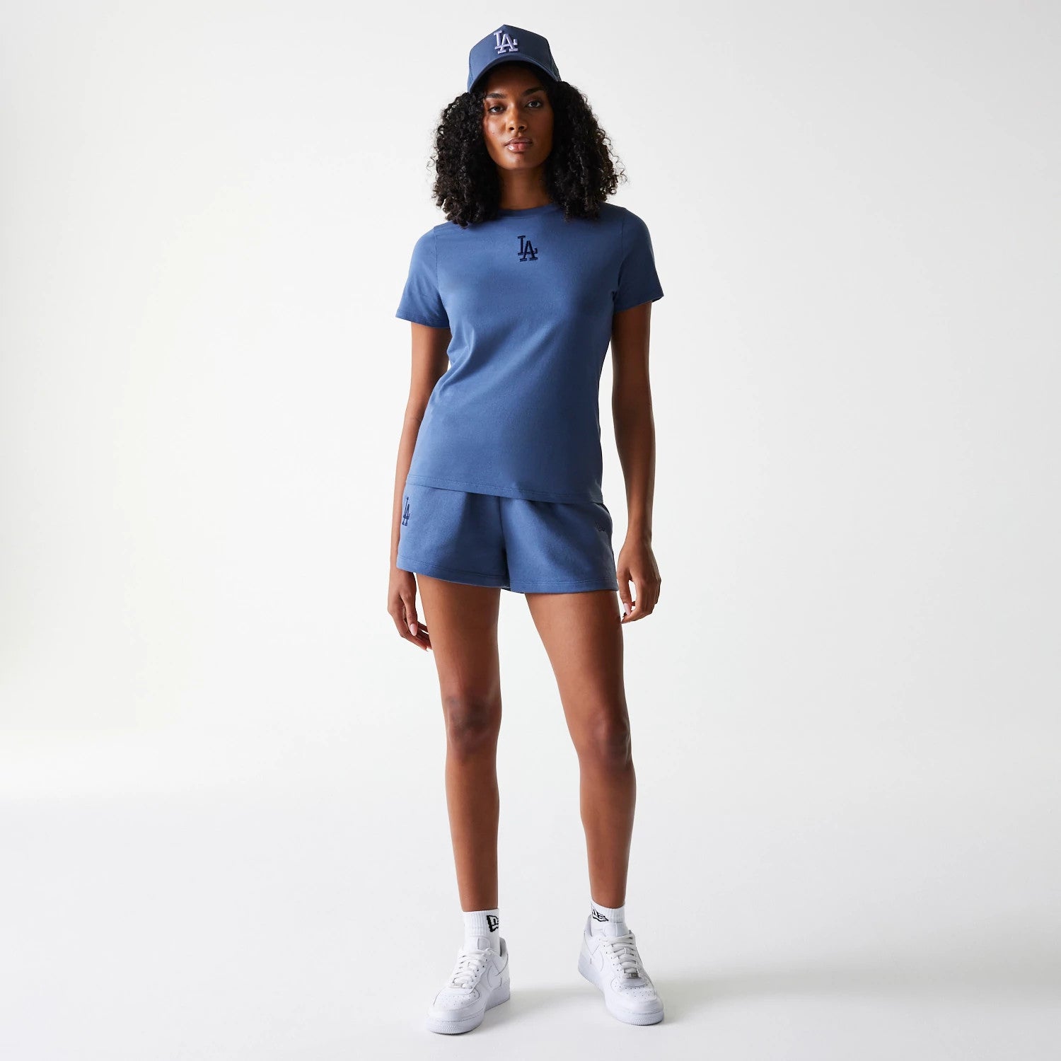 The Female model is wearing LA Dodgers Womens MLB Midi League Essential Dark Blue Shorts 7