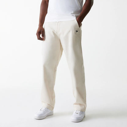 The Male model is wearing New Era Light Beige Chino Trousers 3