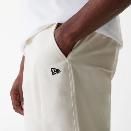 The Male model is wearing New Era Light Beige Chino Trousers 5