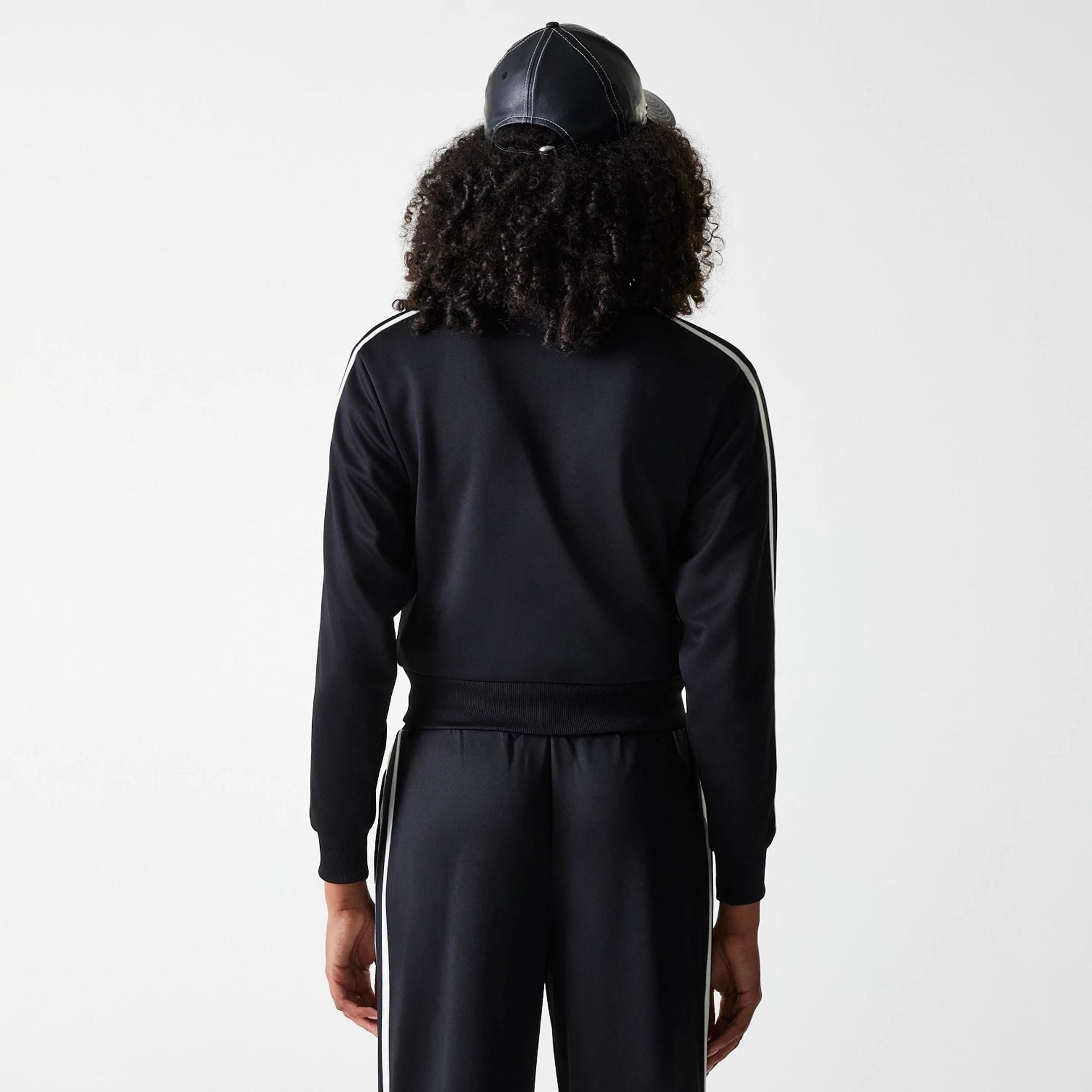 The Female model is wearing New York Yankees Womens MLB Midi Logo Black Track Jacket 2