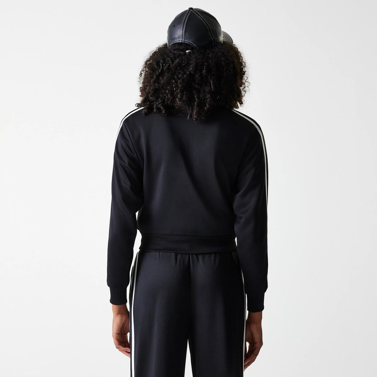 The Female model is wearing New York Yankees Womens MLB Midi Logo Black Track Jacket 2