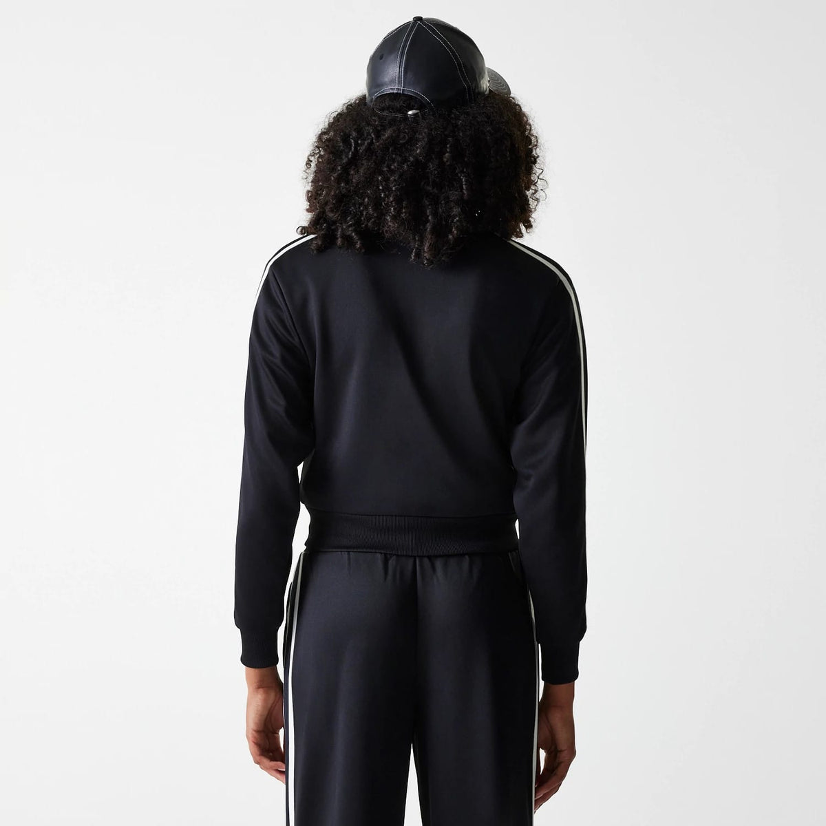The Female model is wearing New York Yankees Womens MLB Midi Logo Black Track Jacket 2