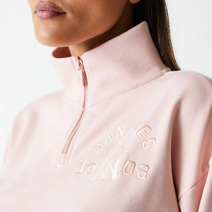 The Female model is wearing New York Yankees Womens MLB Tonal Pastel Pink Cropped 1/4 Zip Sweater 4