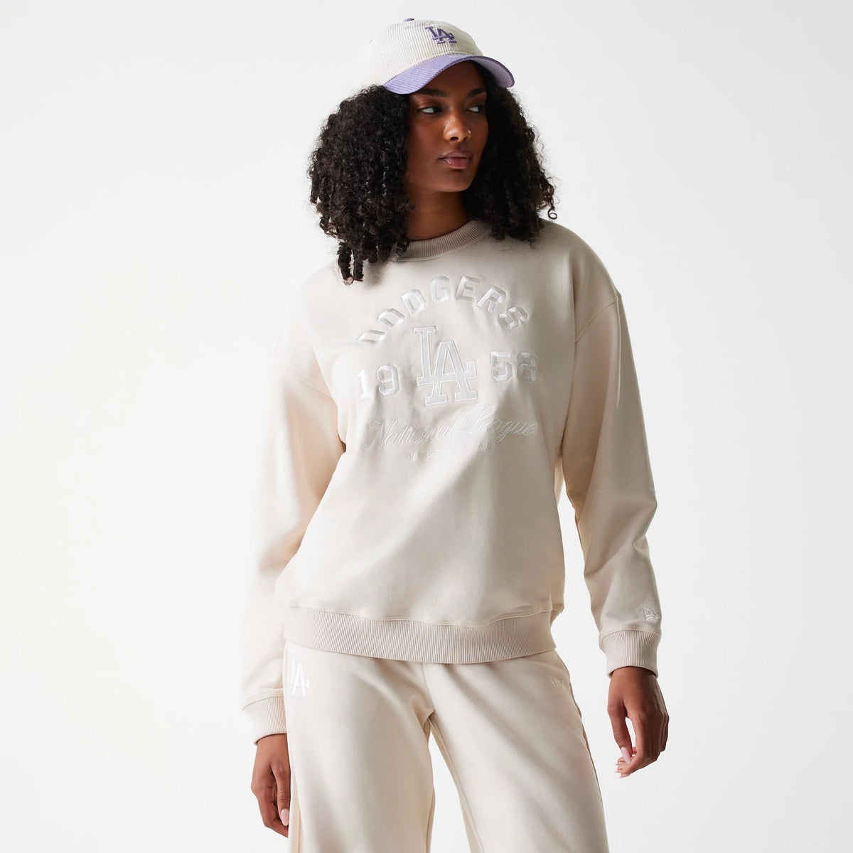 The Female model is wearing LA Dodgers Womens MLB Tonal Graphic Light Beige Oversized Crew Neck Sweater 1
