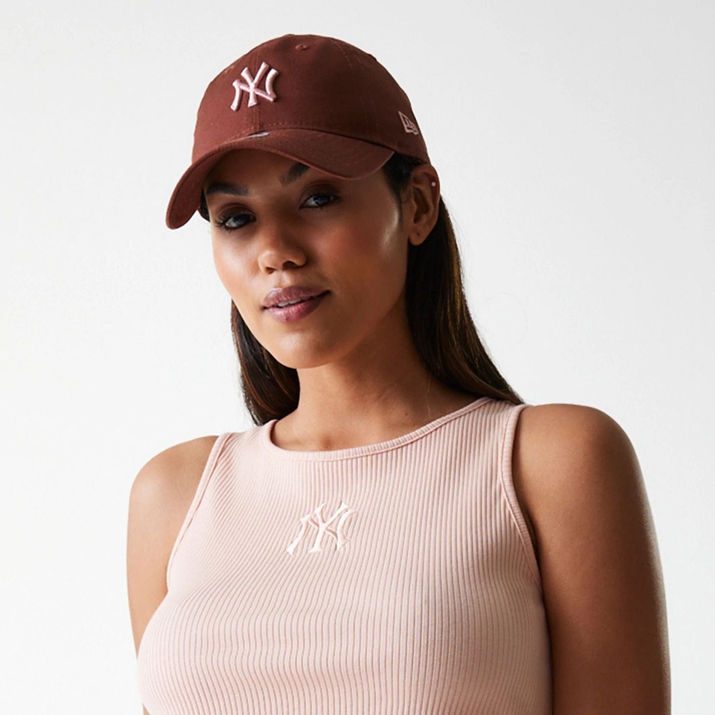 The Female model is wearing New York Yankees Womens MLB Rib Pastel Pink Rib Tank Top 6