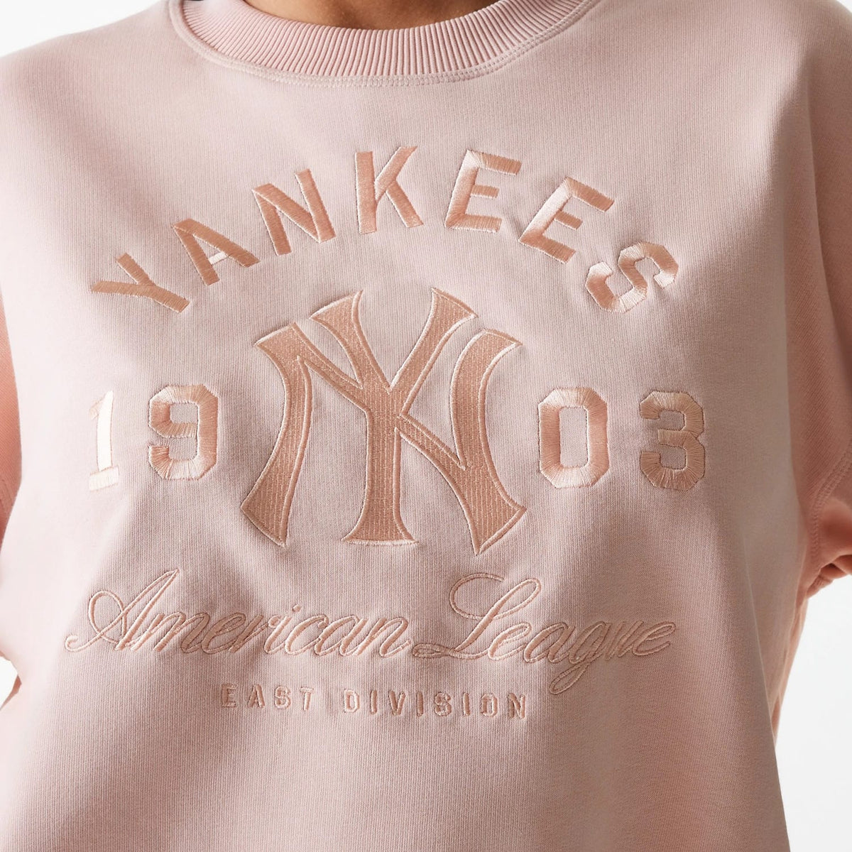 The Female model is wearing New York Yankees Womens MLB Tonal Graphic Pastel Pink Oversized Crew Neck Sweater 4