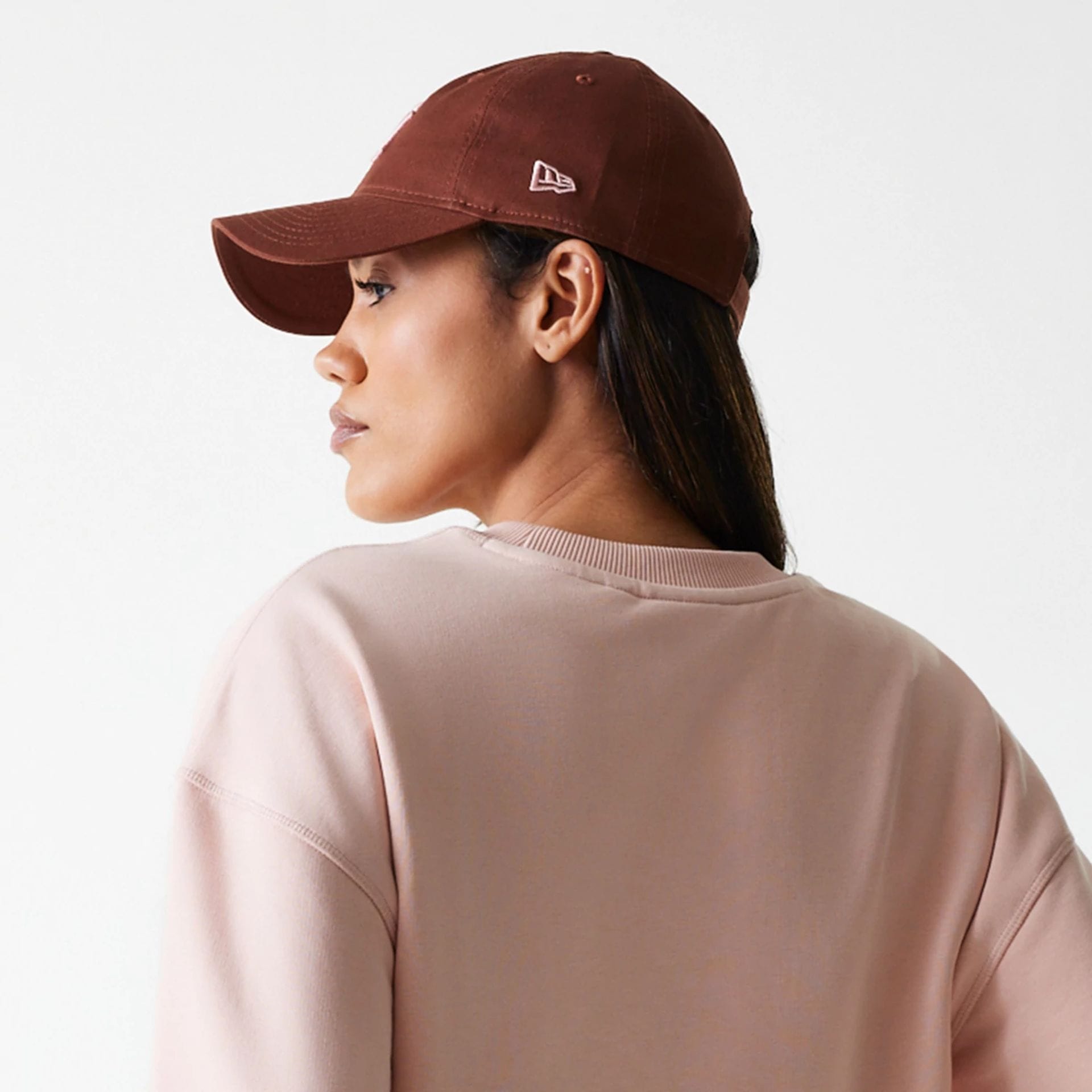 The Female model is wearing New York Yankees Womens MLB Tonal Graphic Pastel Pink Oversized Crew Neck Sweater 7