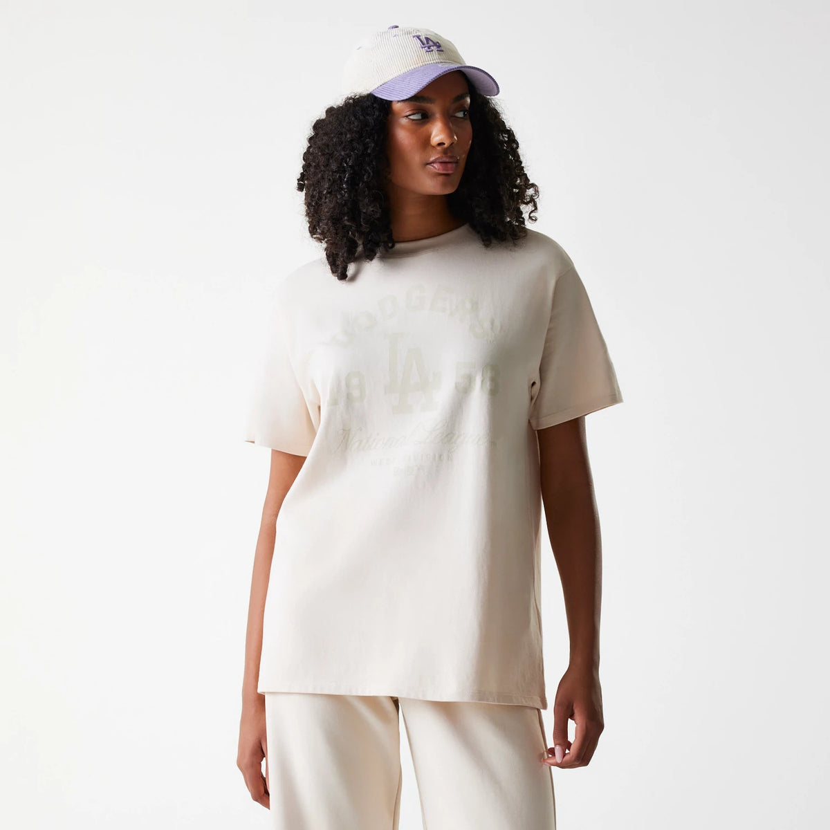 The Female model is wearing LA Dodgers Womens MLB Tonal Graphic Light Beige Oversized T-Shirt 1