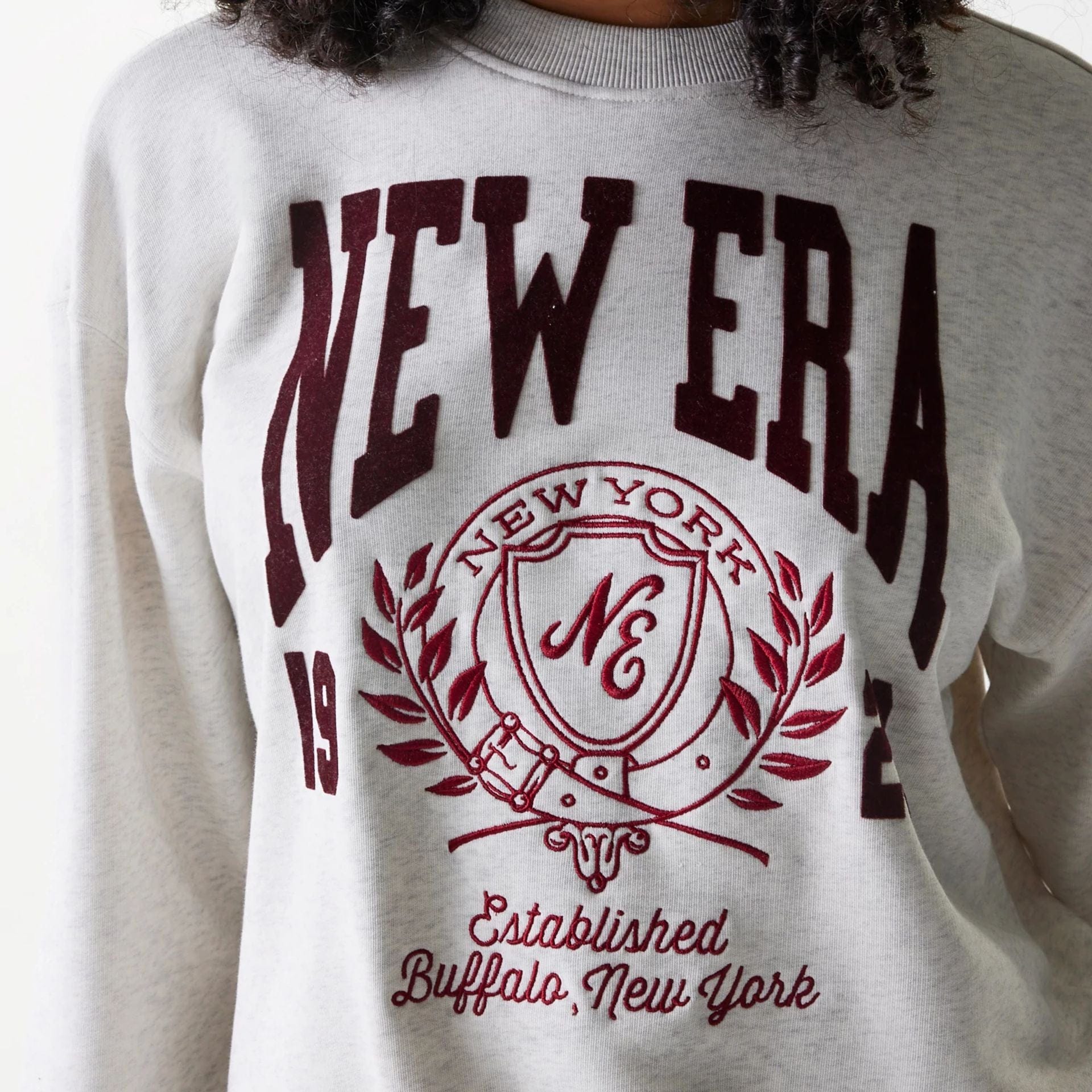 The Female model is wearing Womens New Era Crest Graphic Pastel Grey Crew Neck Sweater 5