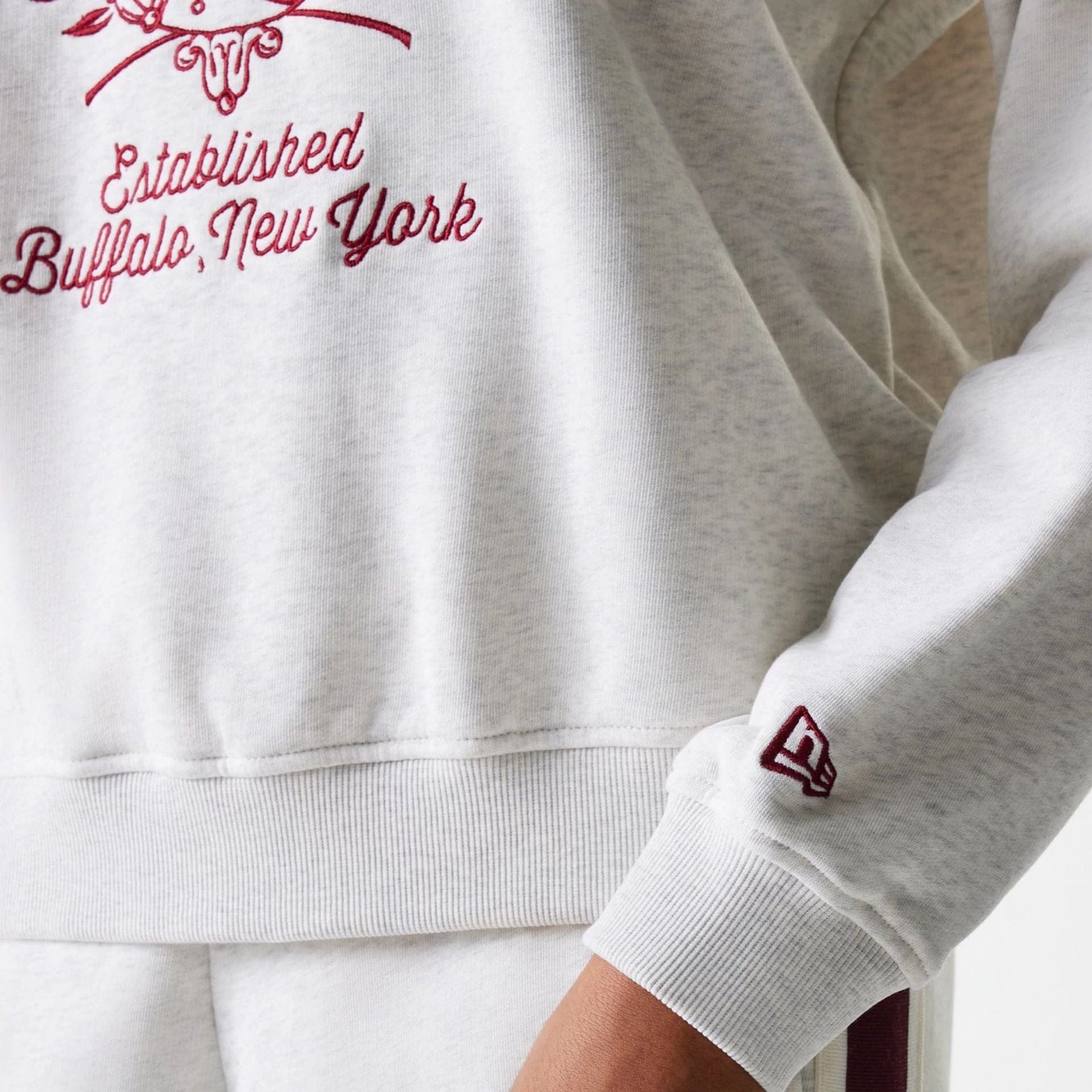 The Female model is wearing Womens New Era Crest Graphic Pastel Grey Crew Neck Sweater 6