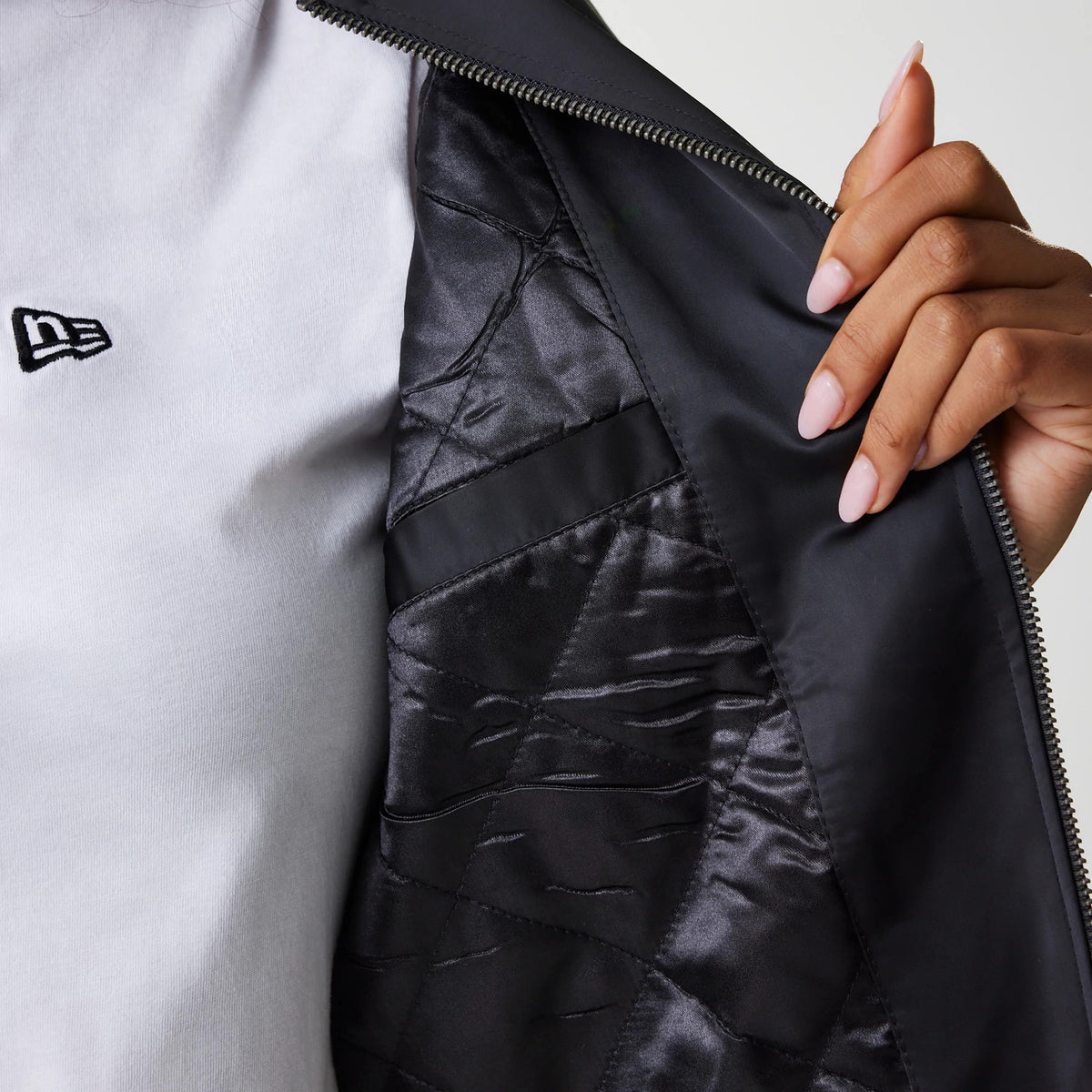 The Female model is wearing Womens New Era Satin Black Satin Bomber Jacket 6