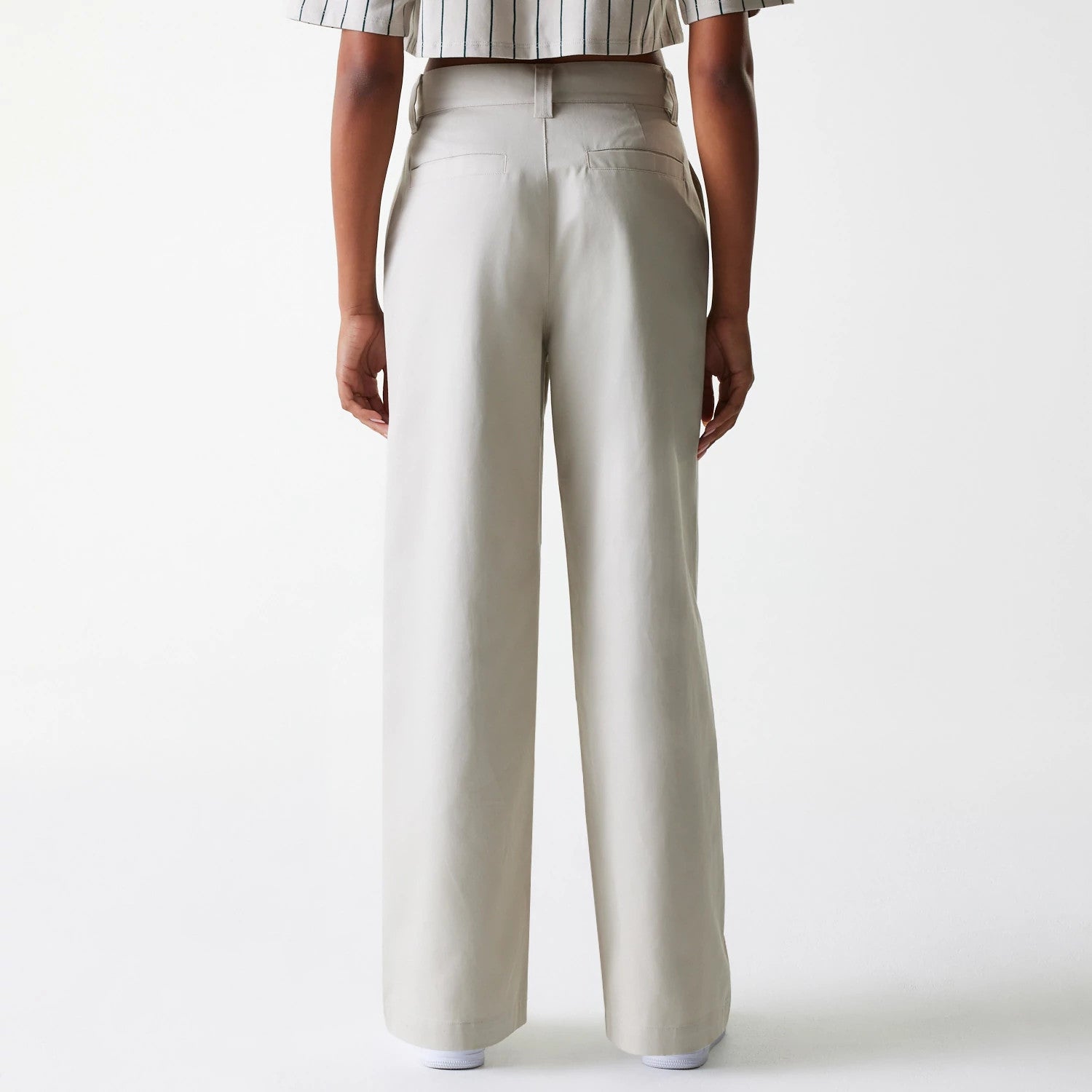 The Female model is wearing Womens New Era Light Beige Wide Leg Chino Trousers 2