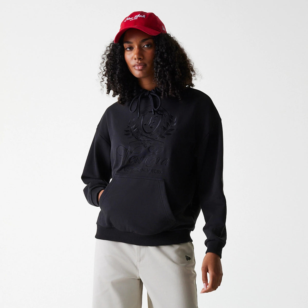 The Female model is wearing Womens New Era Crest Black Pullover Hoodie 6