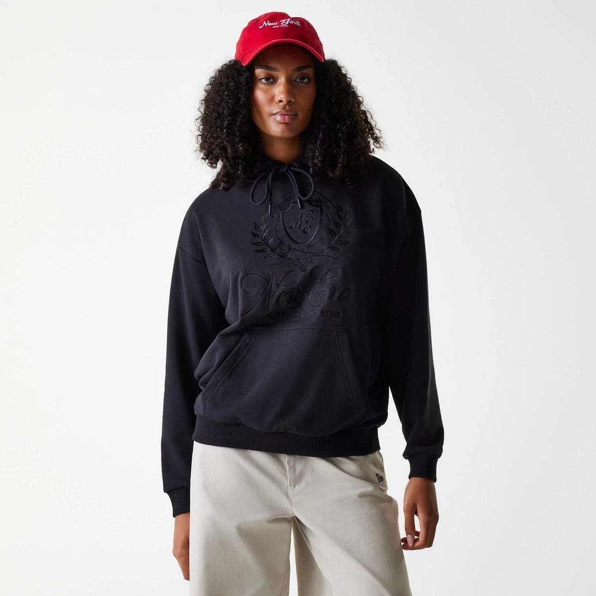 The Female model is wearing Womens New Era Crest Black Pullover Hoodie 1