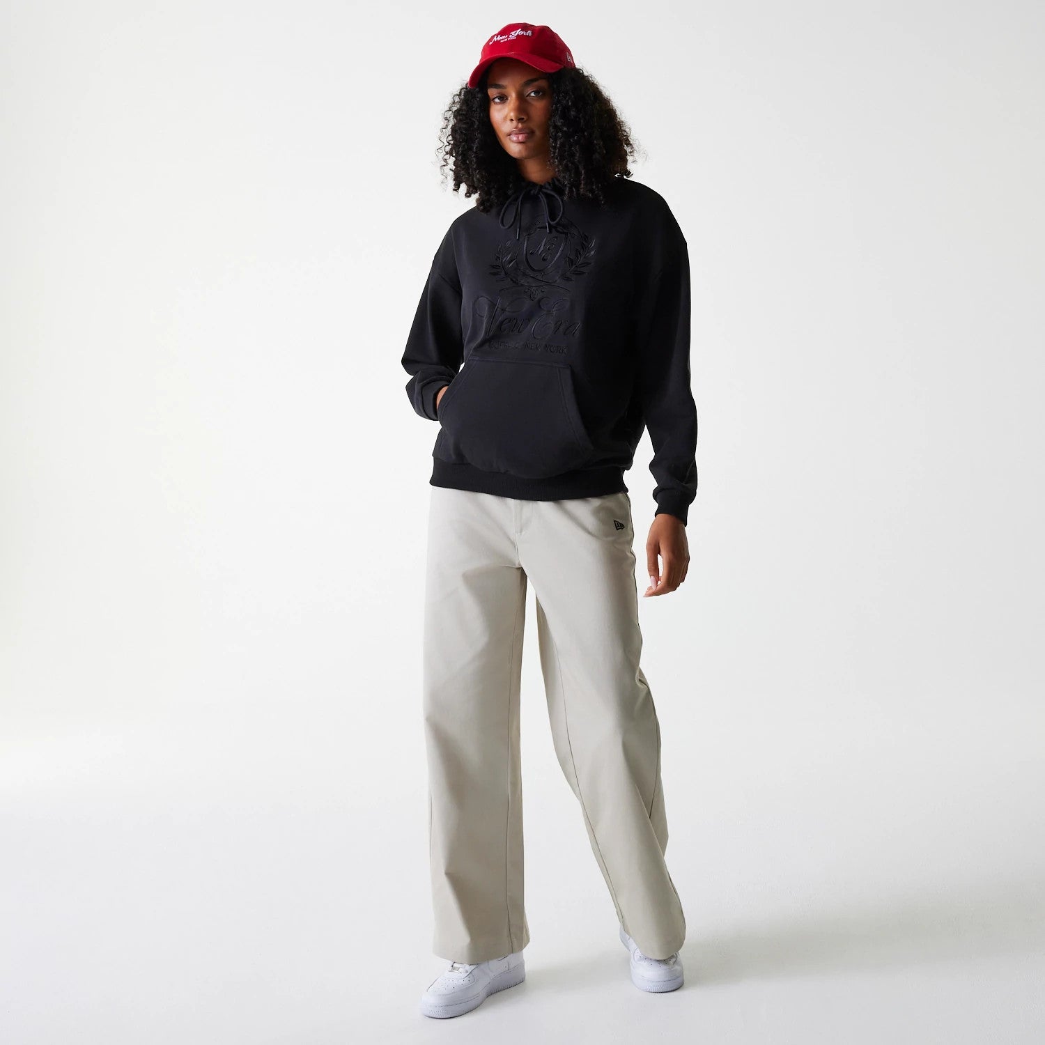 The Female model is wearing Womens New Era Crest Black Pullover Hoodie 8