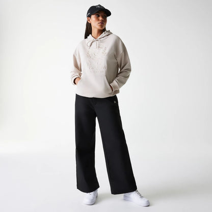 The Female model is wearing Womens New Era Crest Light Beige Pullover Hoodie 8