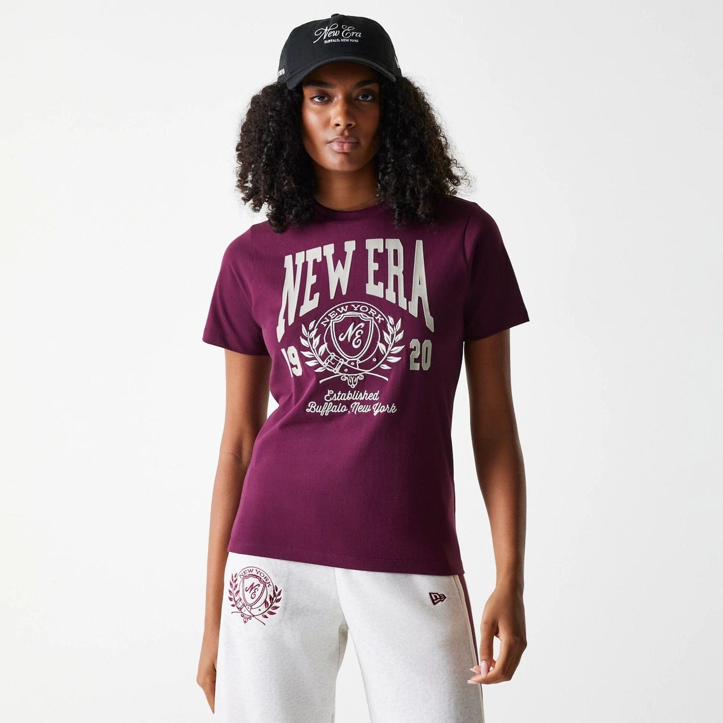 The Female model is wearing Womens New Era Crest Dark Red T-Shirt 1