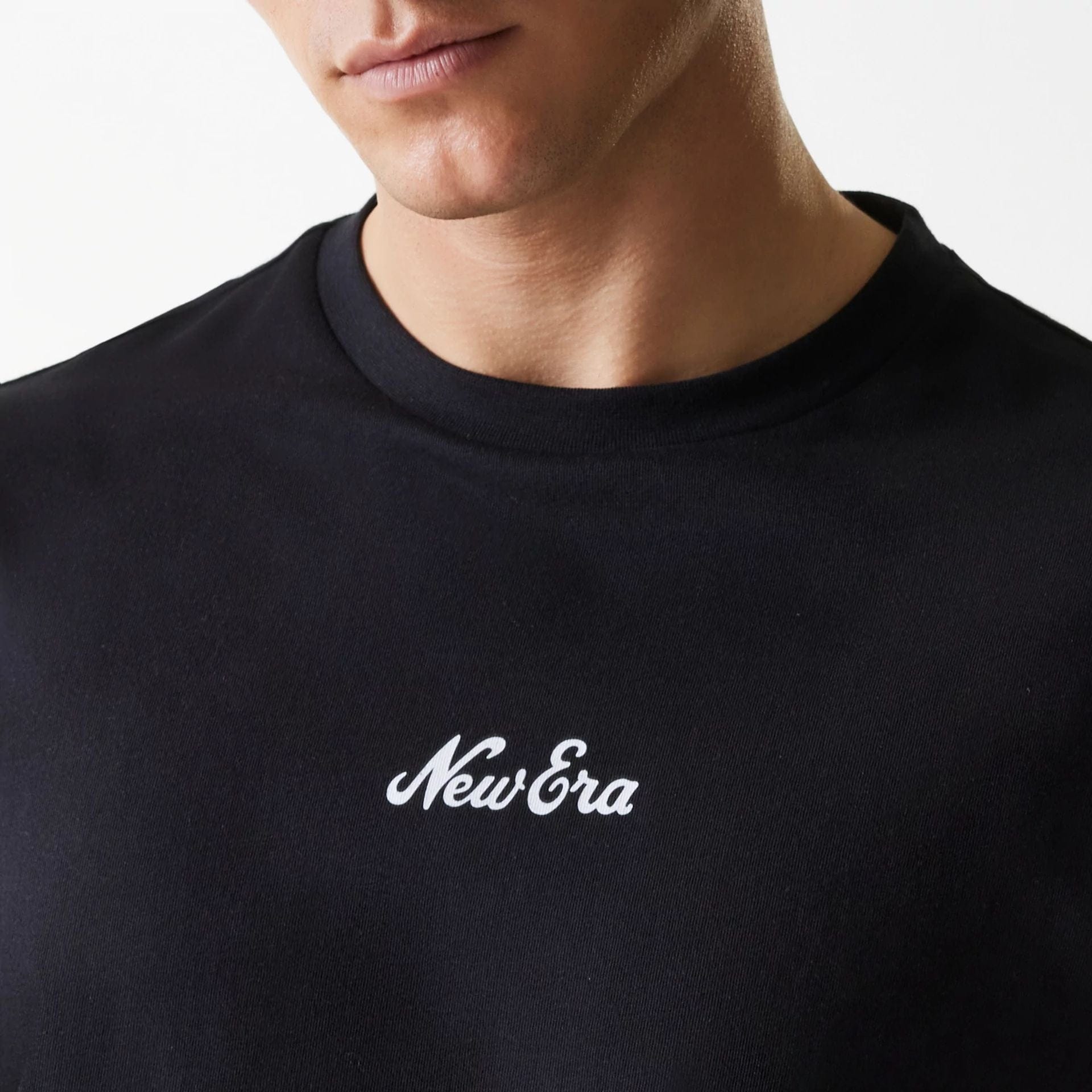 The Male model is wearing New Era Trucker Patch Black Oversized T-Shirt 5