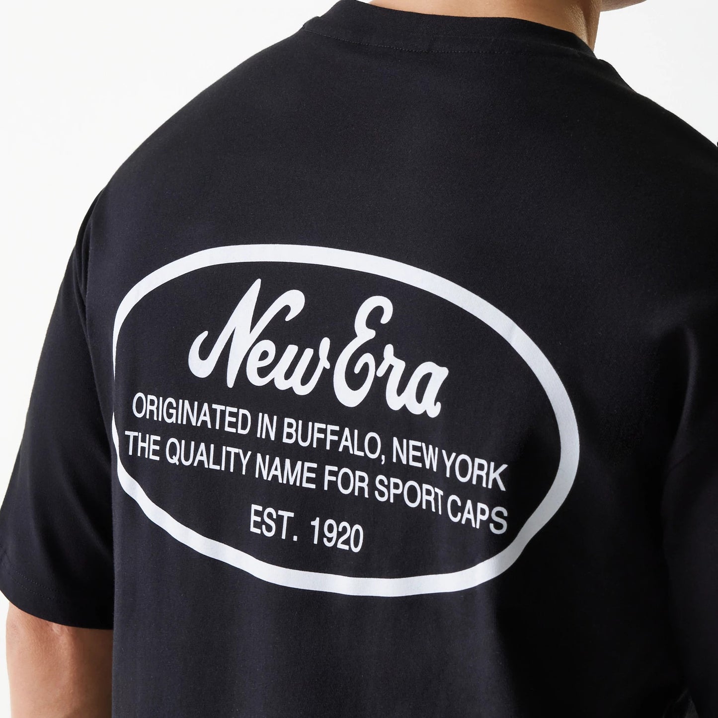 The Male model is wearing New Era Trucker Patch Black Oversized T-Shirt 6