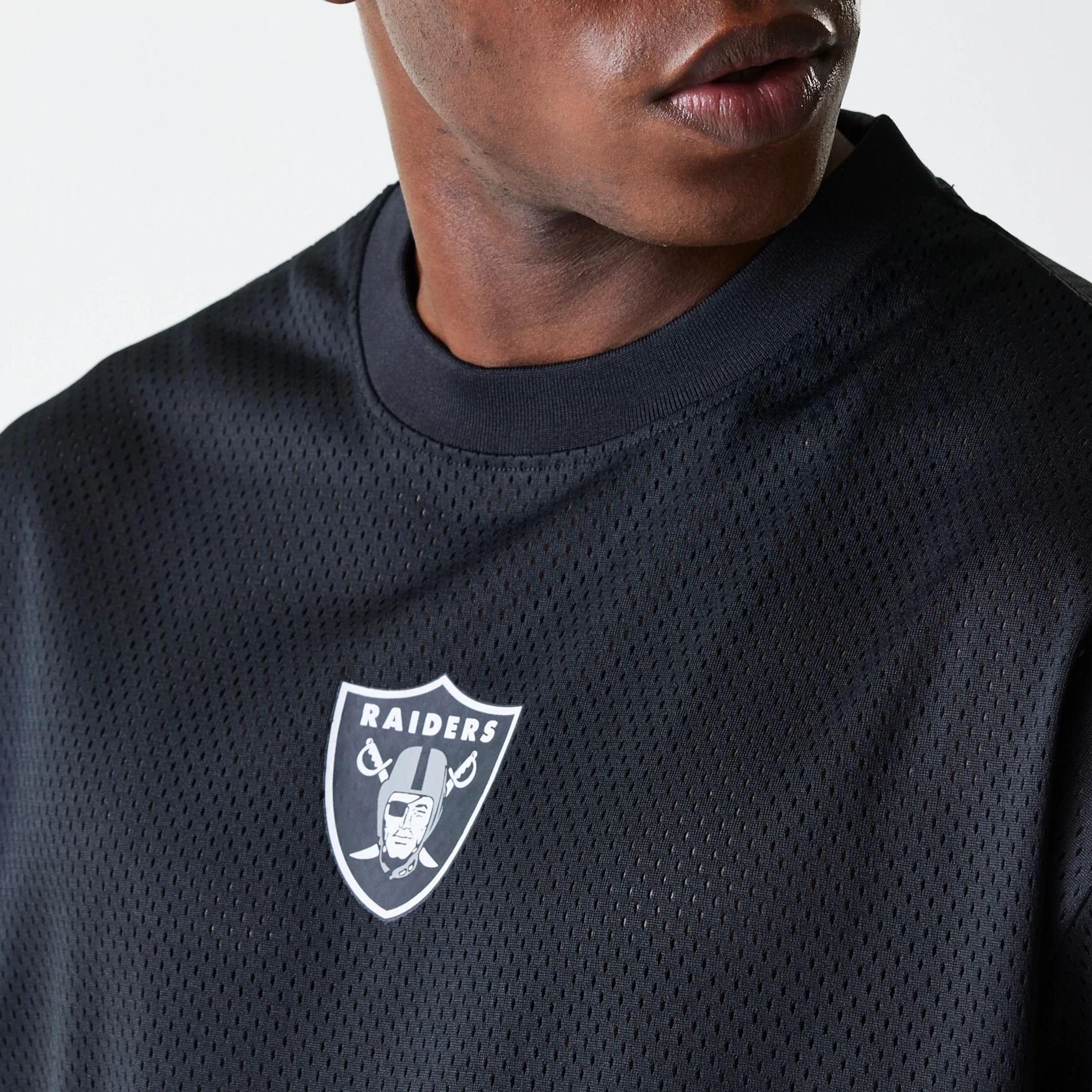 The Male model is wearing Las Vegas Raiders NFL Essentials Black Oversized Mesh T-Shirt 4