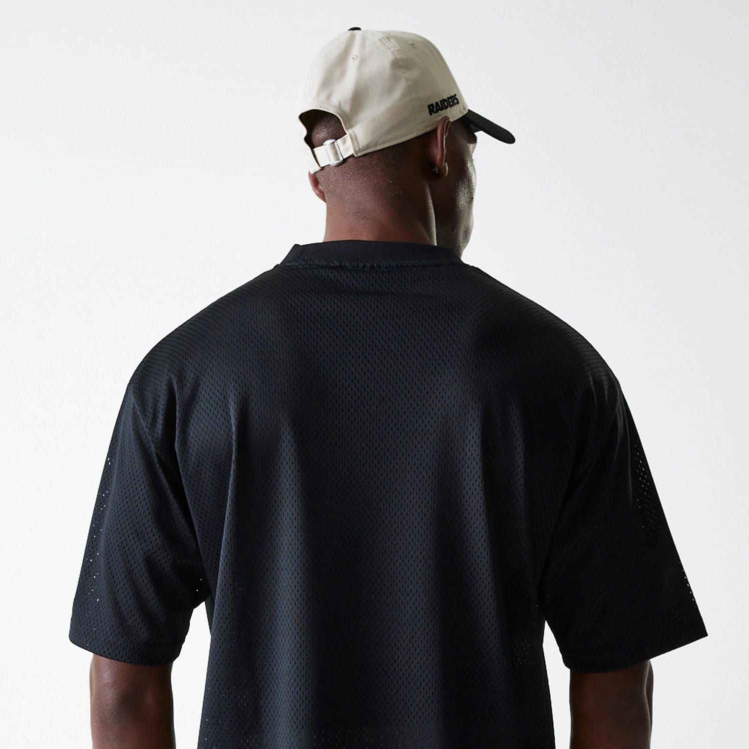 The Male model is wearing Las Vegas Raiders NFL Essentials Black Oversized Mesh T-Shirt 7