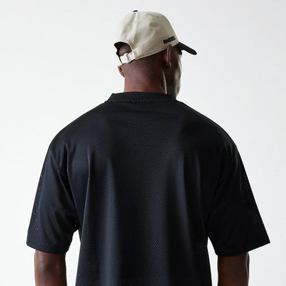 The Male model is wearing Las Vegas Raiders NFL Essentials Black Oversized Mesh T-Shirt 7