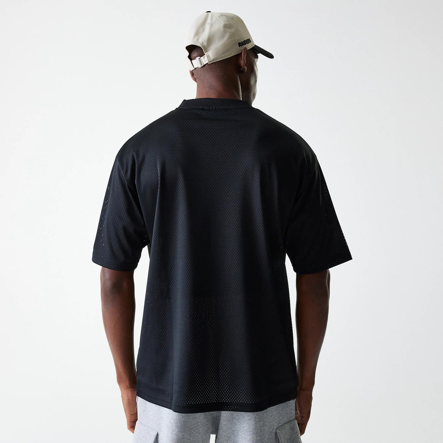 The Male model is wearing Las Vegas Raiders NFL Essentials Black Oversized Mesh T-Shirt 2