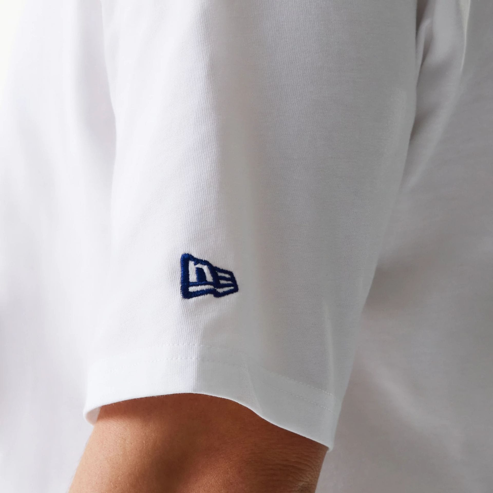 The Male model is wearing New Era Trucker Patch White Oversized T-Shirt 7