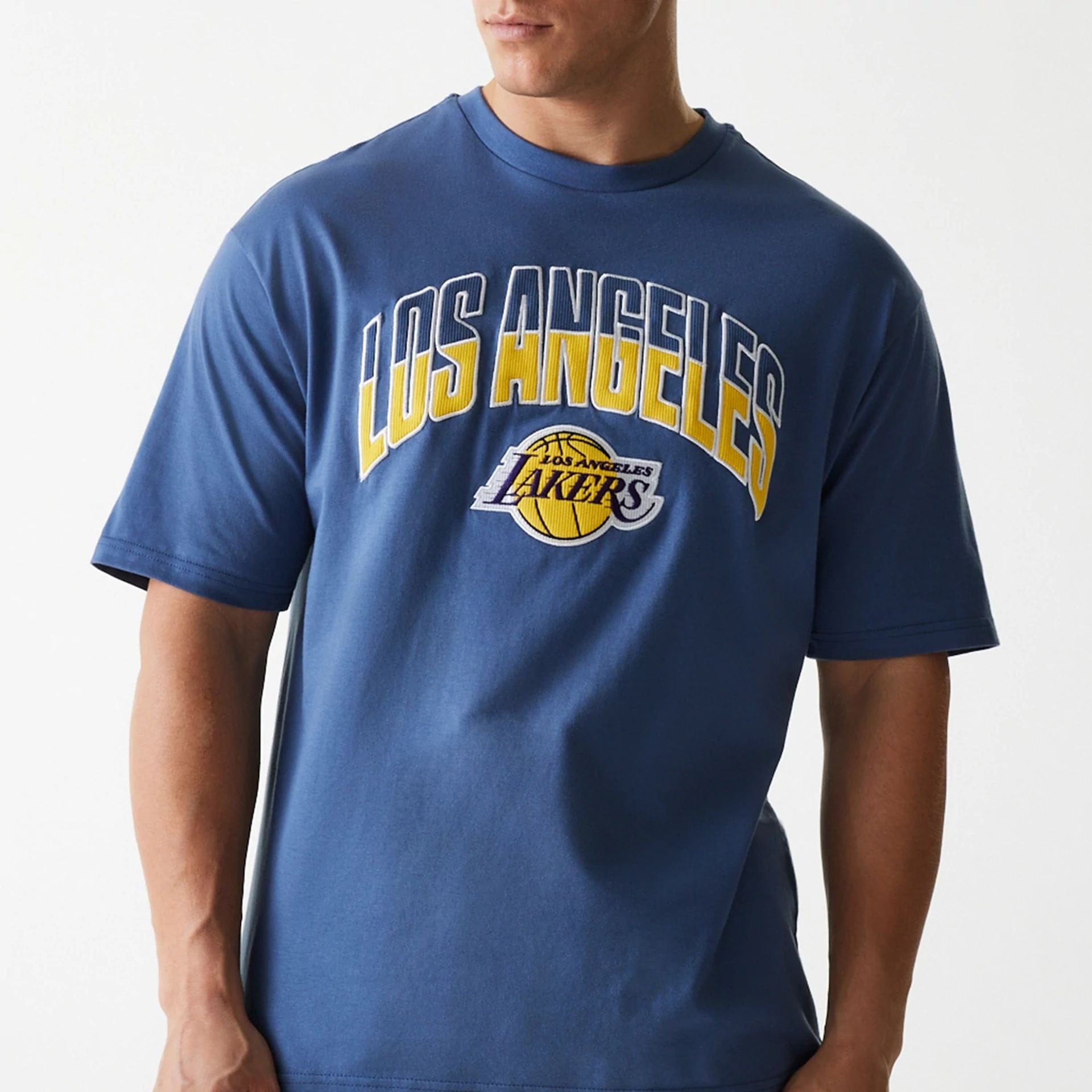 The Male model is wearing LA Lakers NBA Arch Graphic Dark Blue Oversized T-Shirt 5