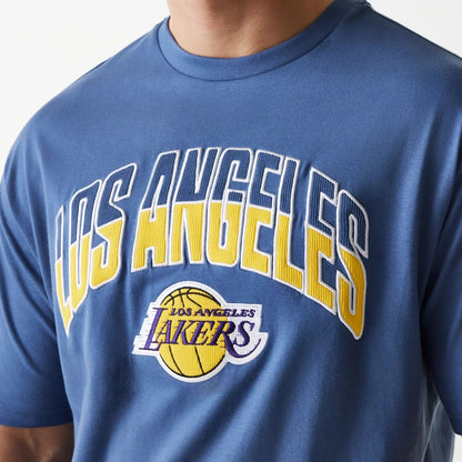 The Male model is wearing LA Lakers NBA Arch Graphic Dark Blue Oversized T-Shirt 6