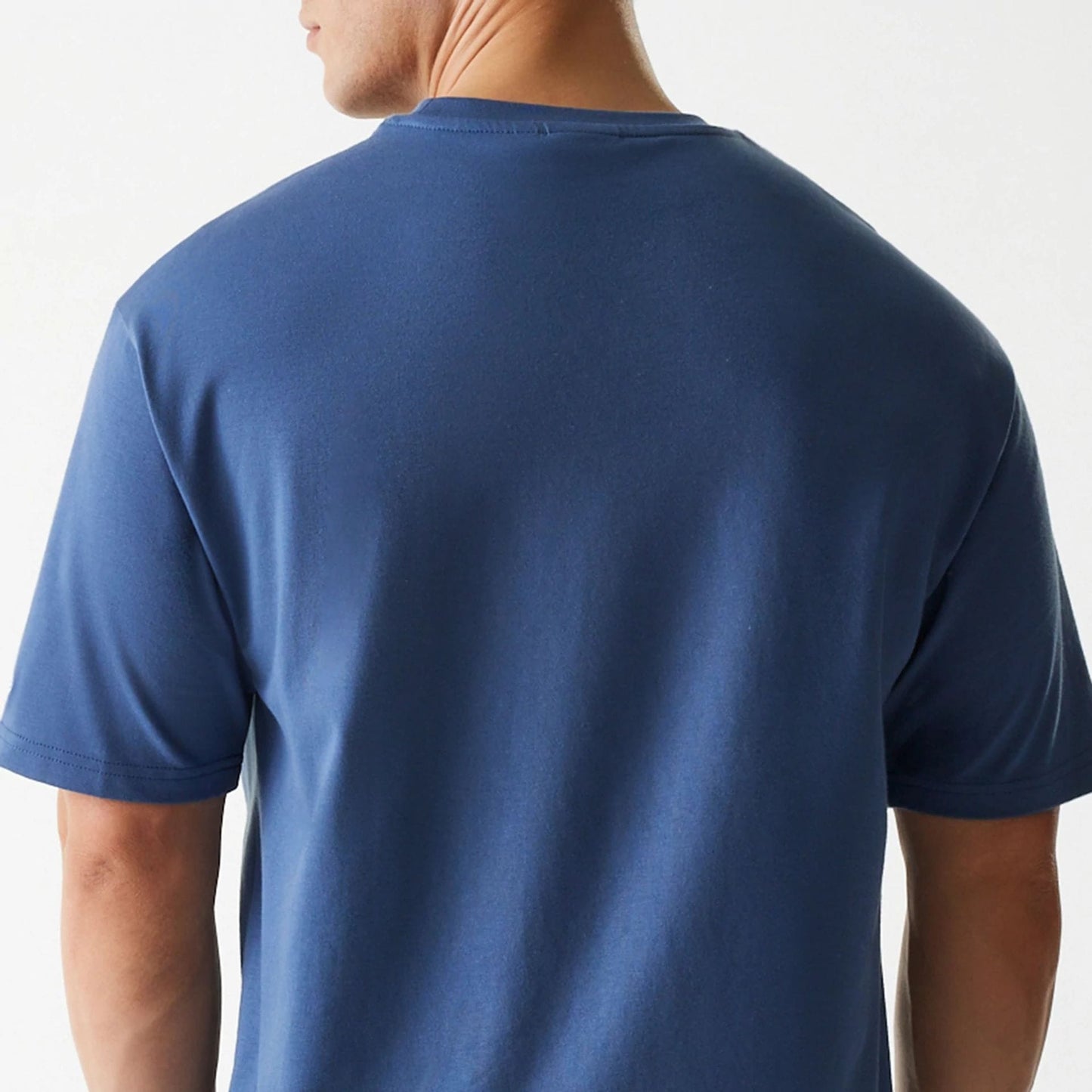 The Male model is wearing LA Lakers NBA Arch Graphic Dark Blue Oversized T-Shirt 4