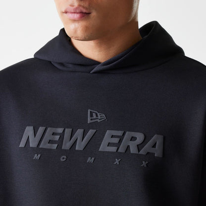 The Male model is wearing New Era Tech Black Oversized Pullover Hoodie 3