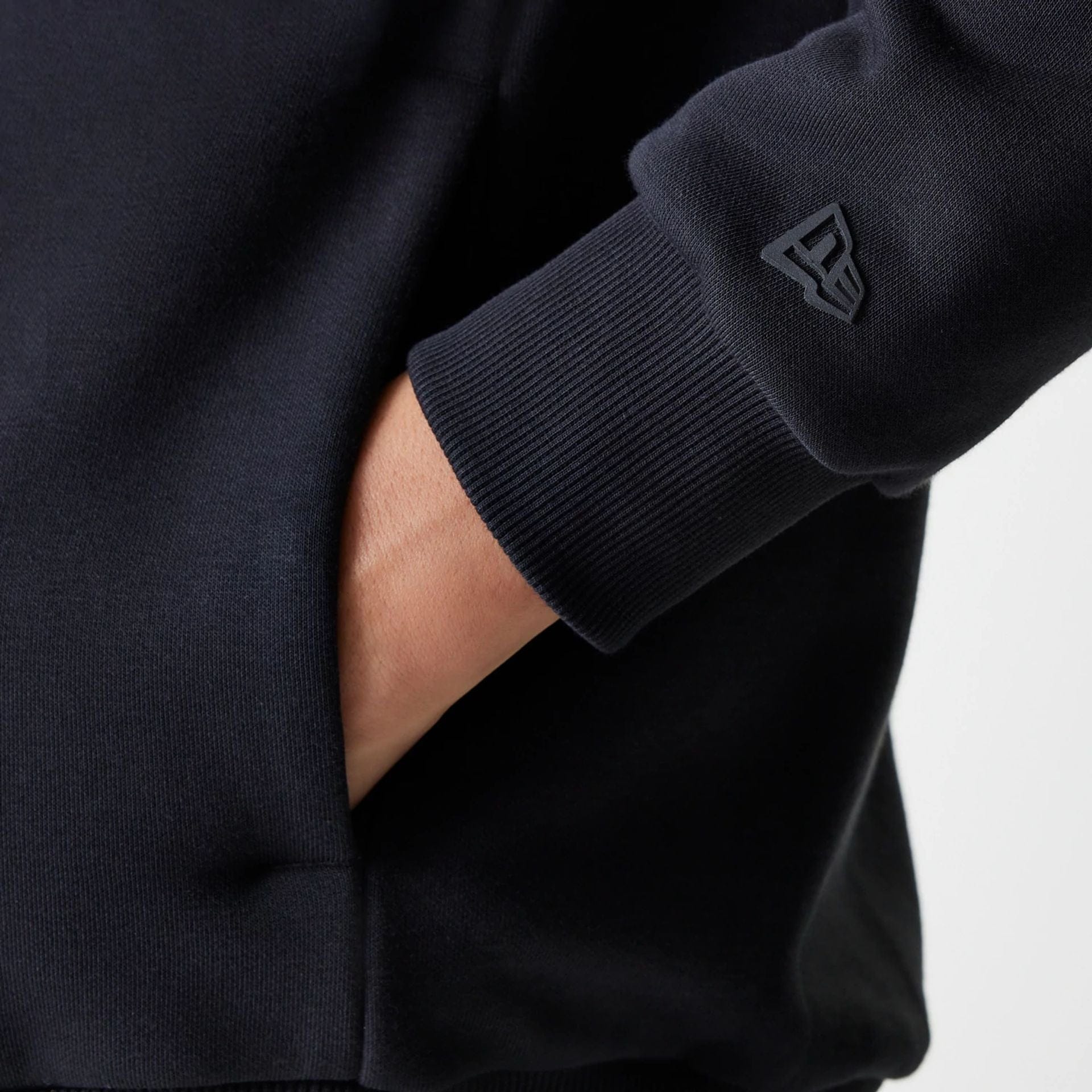 The Male model is wearing New Era Tech Black Oversized Pullover Hoodie 6