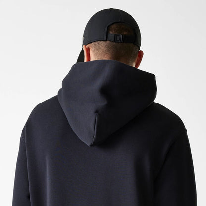 The Male model is wearing New Era Tech Black Oversized Pullover Hoodie 7