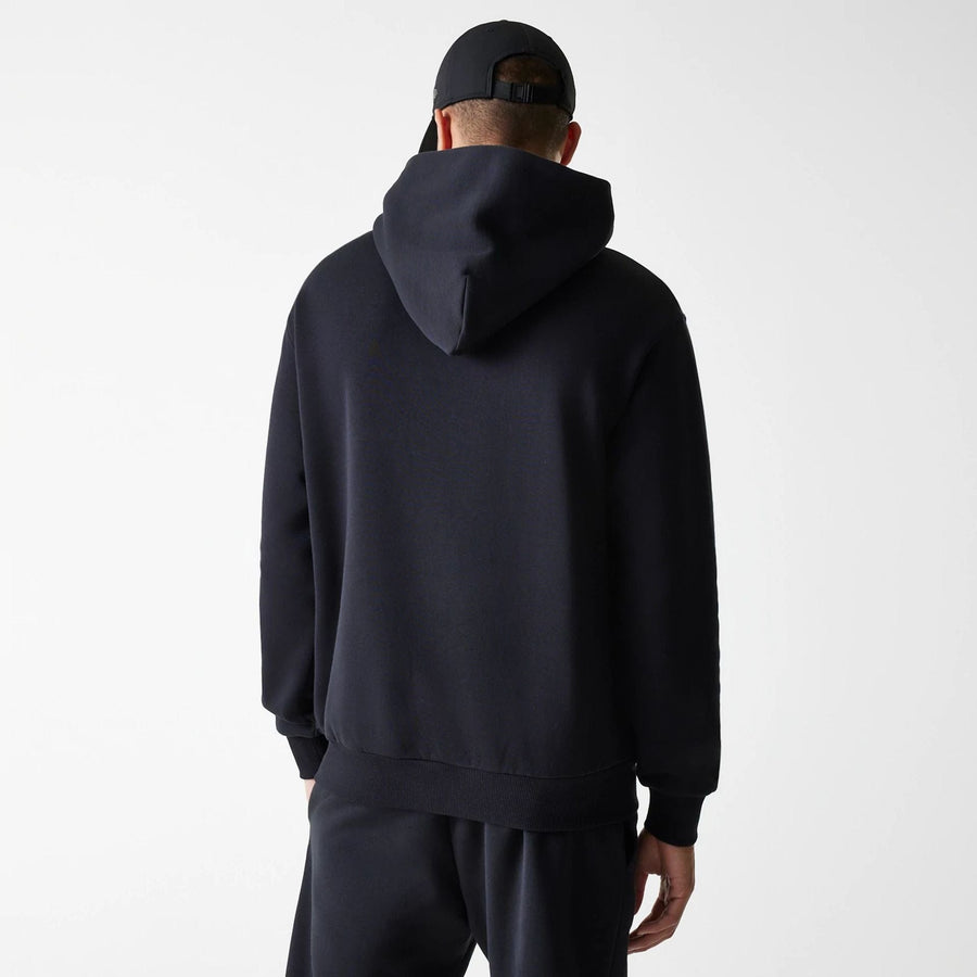 The Male model is wearing New Era Tech Black Oversized Pullover Hoodie 2