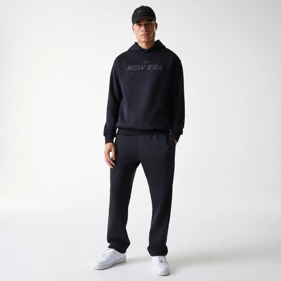 The Male model is wearing New Era Tech Black Oversized Pullover Hoodie 8
