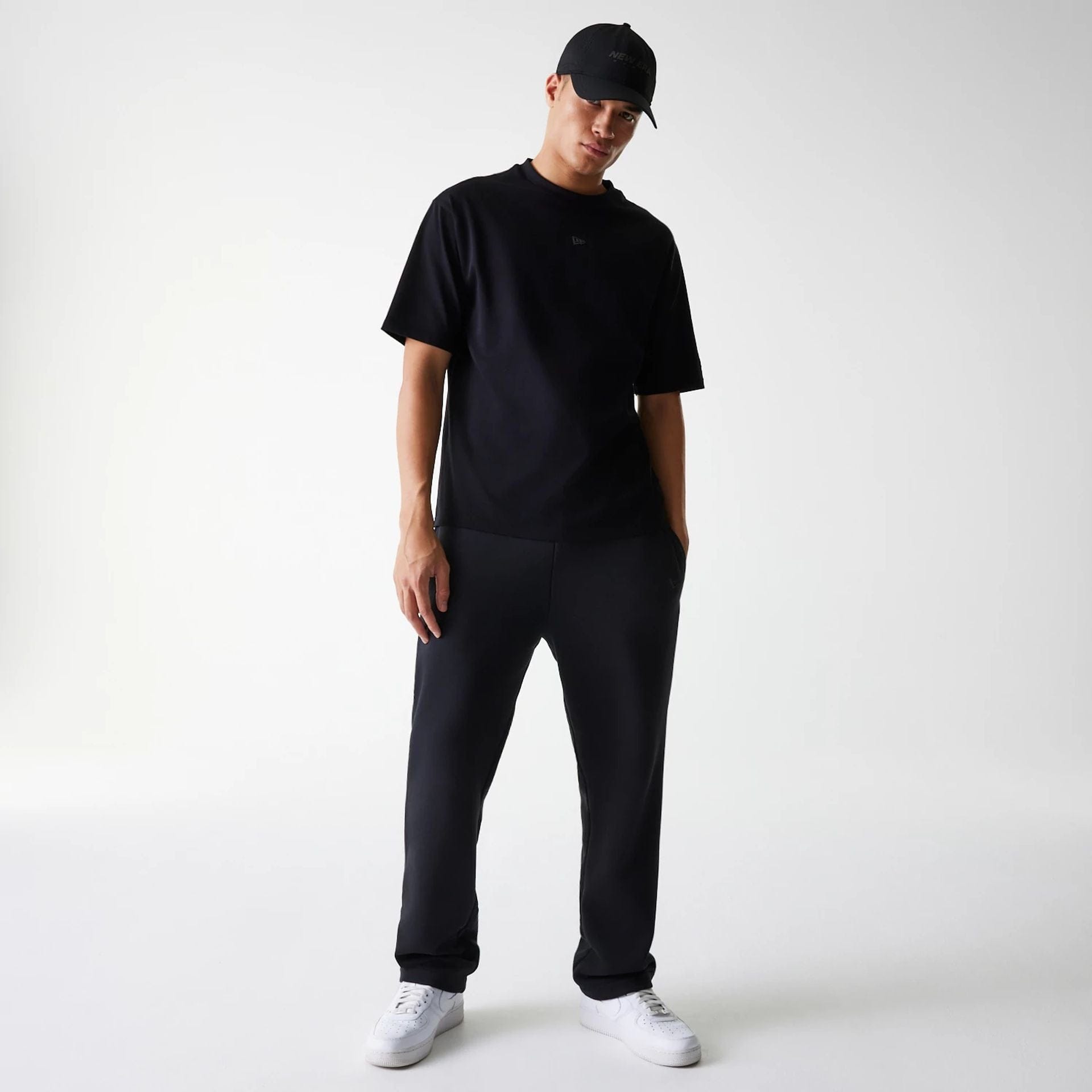 The Male model is wearing New Era Tech Black Oversized T-Shirt 8