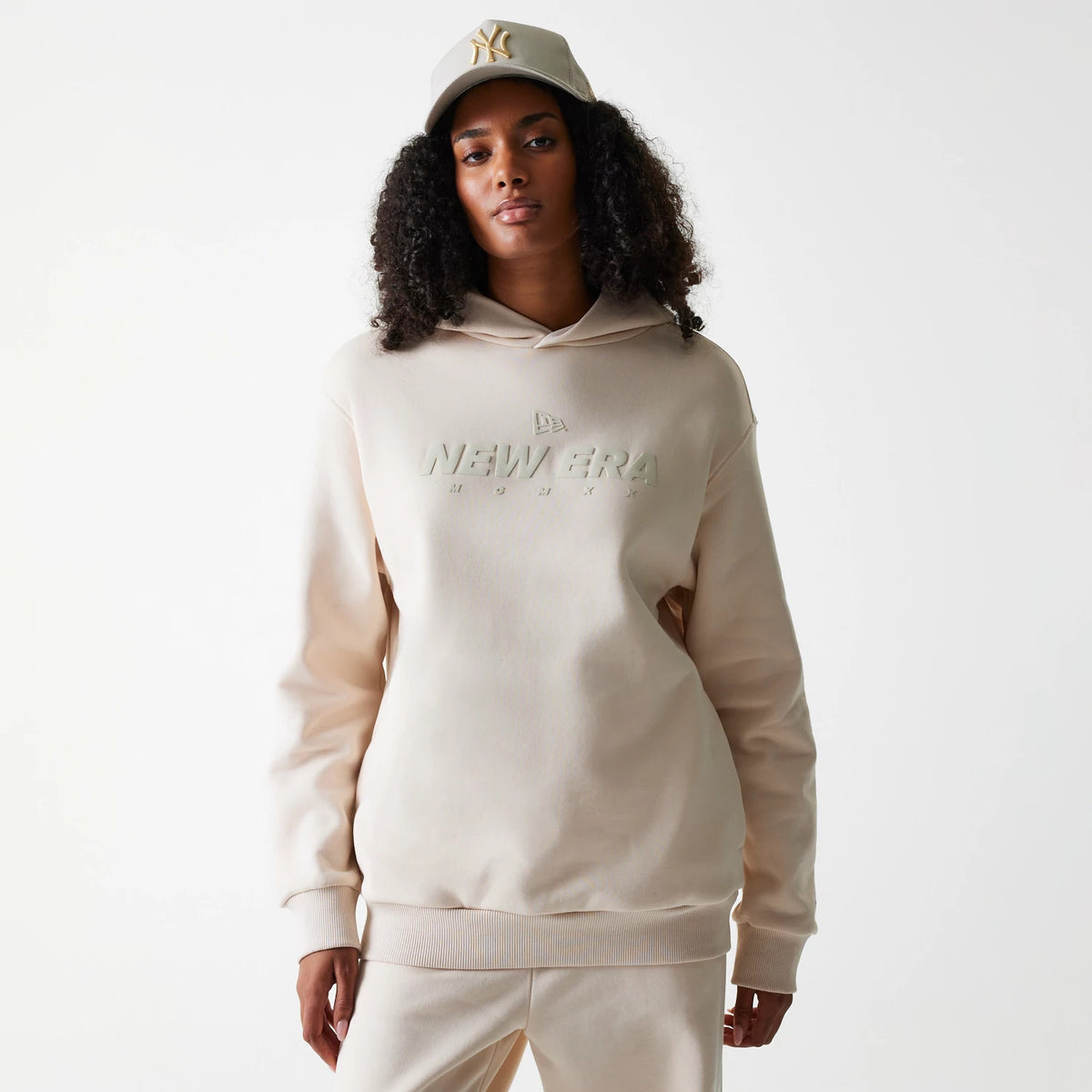 The Male model is wearing New Era Tech Light Beige Oversized Pullover Hoodie 4