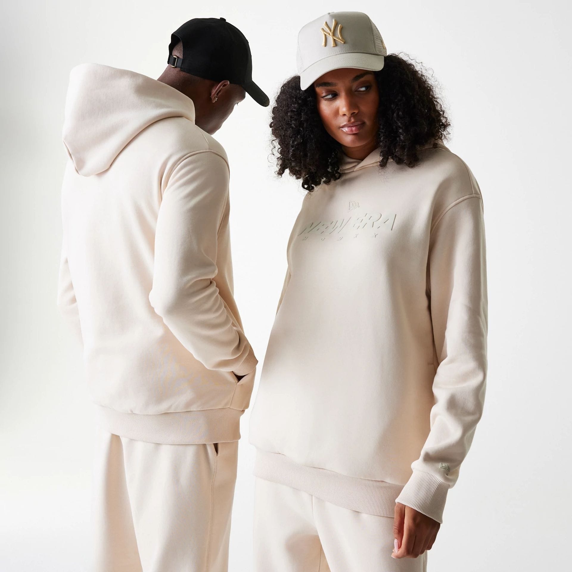 The Male model is wearing New Era Tech Light Beige Oversized Pullover Hoodie 1
