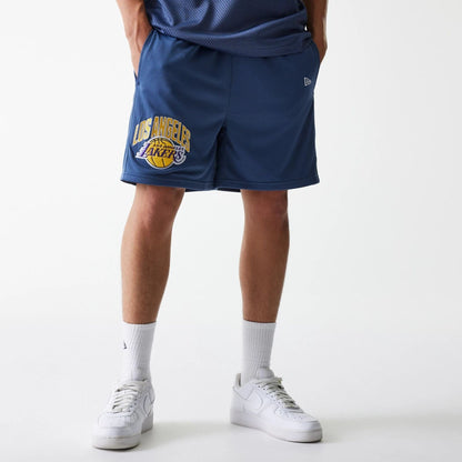 The Male model is wearing LA Lakers NBA Arch Graphic Dark Blue Mesh Shorts 1