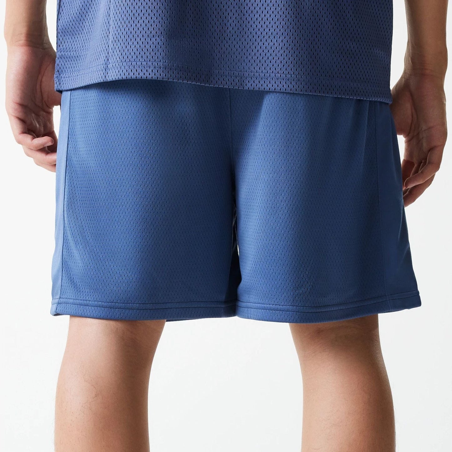 The Male model is wearing LA Lakers NBA Arch Graphic Dark Blue Mesh Shorts 7