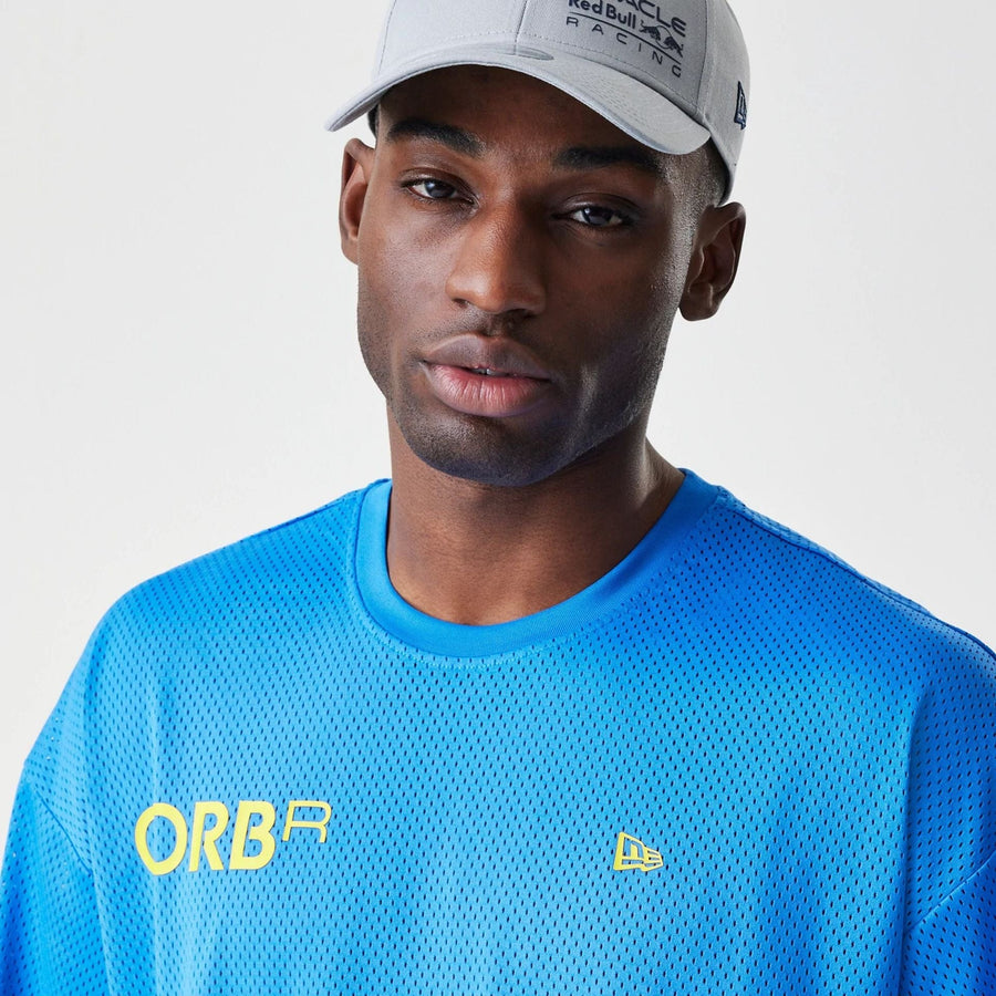 The Male model is wearing Red Bull Racing Graphic Mesh Blue Oversized T-Shirt 3