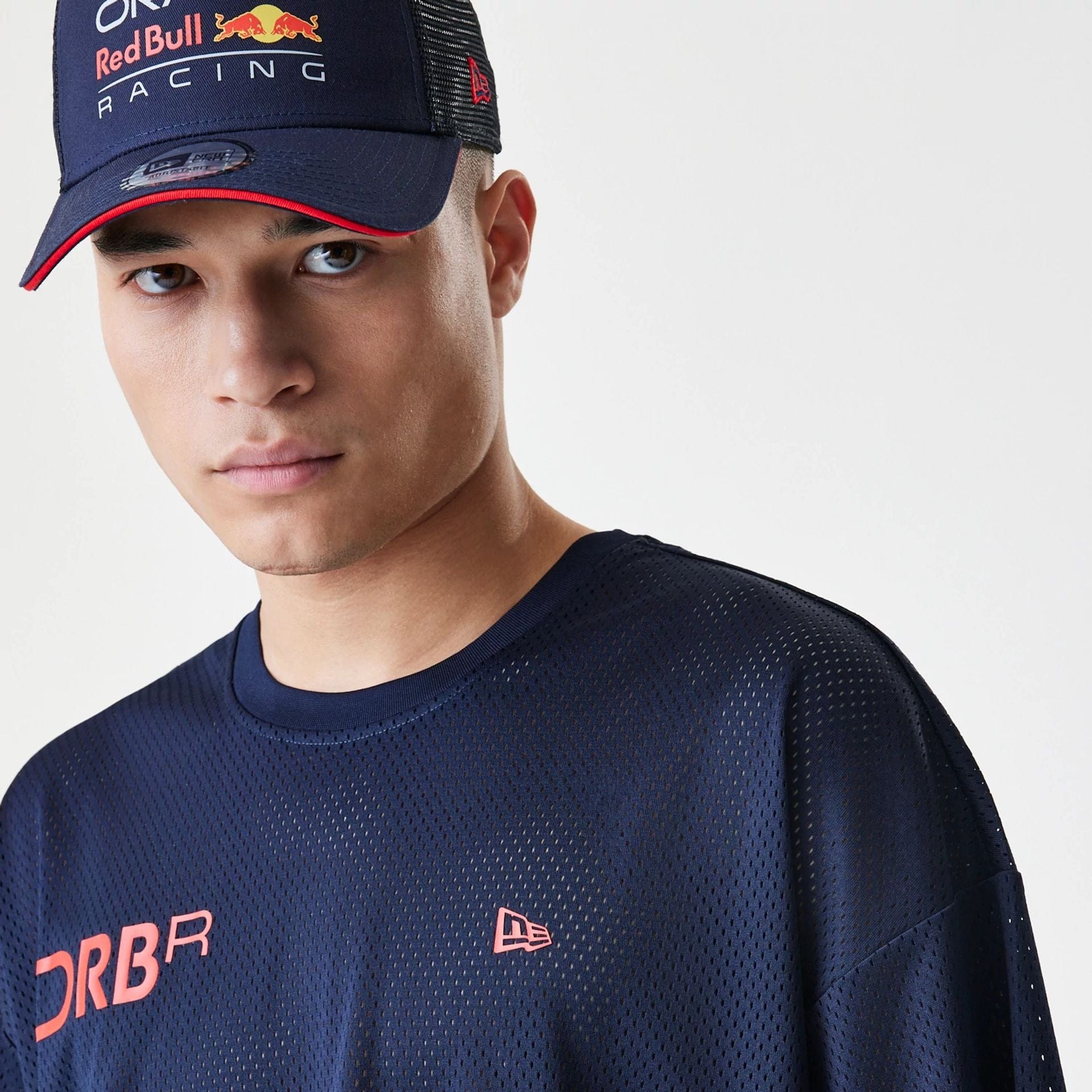 The Male model is wearing Red Bull Racing Graphic Mesh Dark Blue Oversized T-Shirt 6