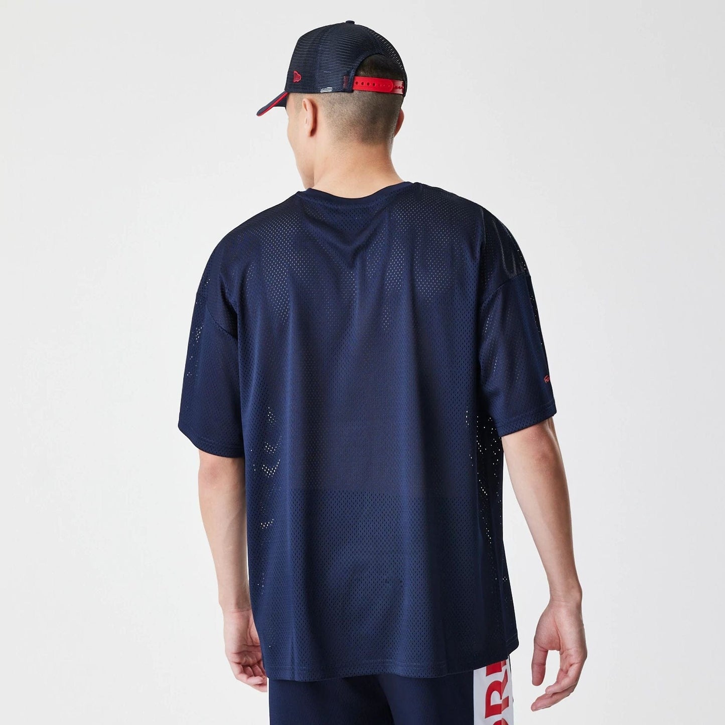 The Male model is wearing Red Bull Racing Graphic Mesh Dark Blue Oversized T-Shirt 2